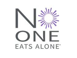 "NO ONE EATS ALONE®" logo with a purple sunburst replacing the "O".